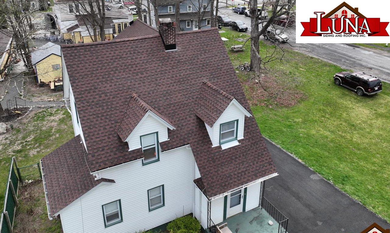 Contractor installing a clay tile roof on a home